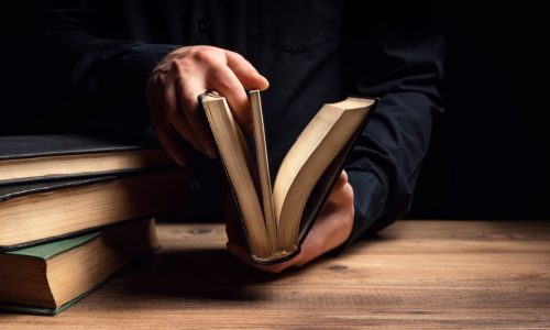 Man illuminates the darkness by reading a book